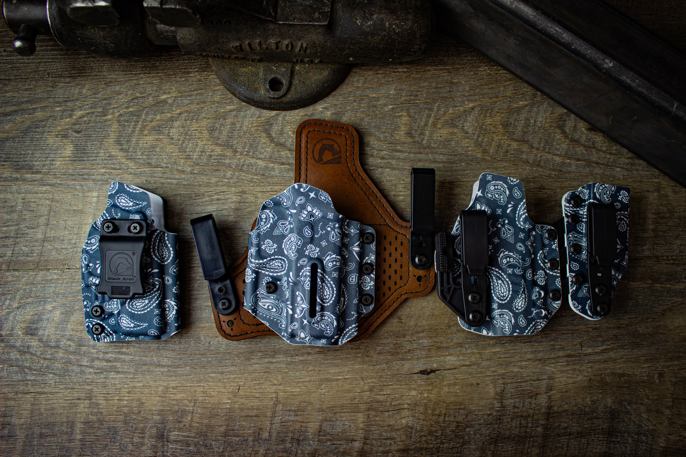 April 2025 Holster of the Month Paisley collection. Shown left to right: Rev-Con for Glock 43X MOS with Foamy Clip, Protos-M for Walther PDP 4" with polymer clips, and Entrada for Sig P365 XL with ModWing and Griphooks.